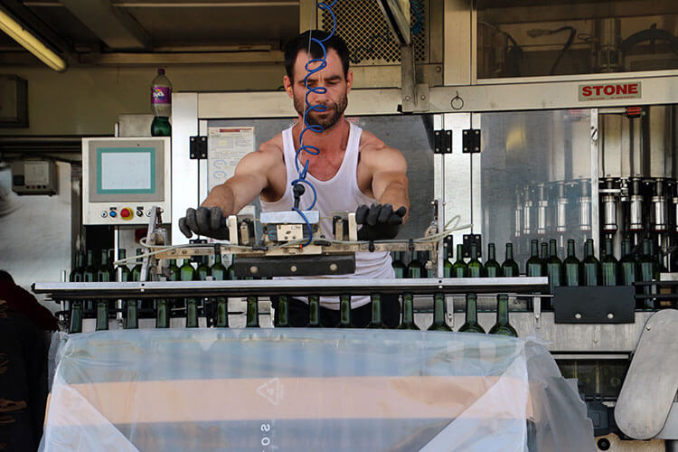 A man bottling the latest vintage at Chateau Kirwan