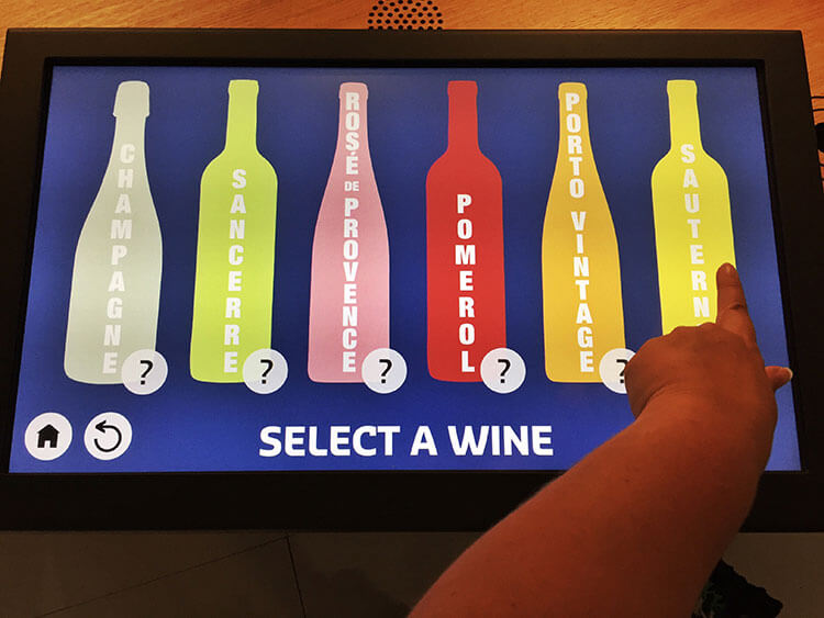 The screen of one of the exhibitis on which you select a type of wine to learning about pairing food with it at La Cité du Vin