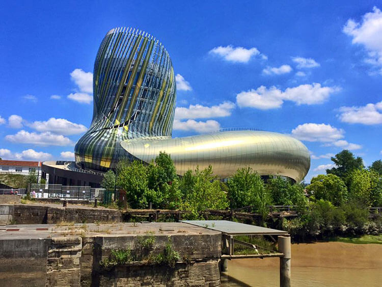 The wine decanter shaped La Cité du Vin on a sunny day in Bordeaux