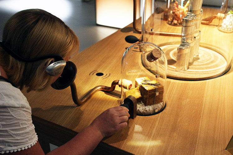 Jennifer sniffs red wine aromas from one of the exhibits at La Cité du Vin