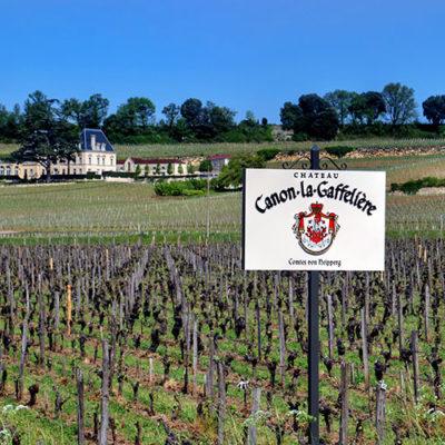 The Château Canon-la-Gaffelière sign marking a plot of their vineyards with another Saint-Êmilion château in the distance