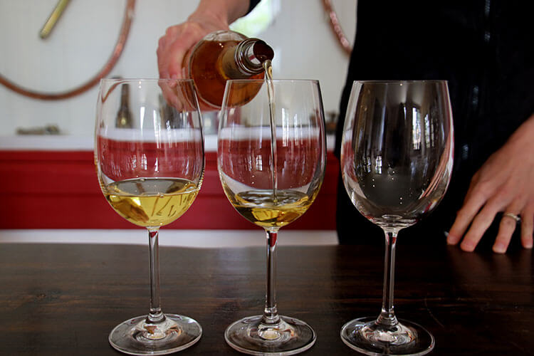 The three vintages being poured into wine glasses at Chateau Coutet Barsac