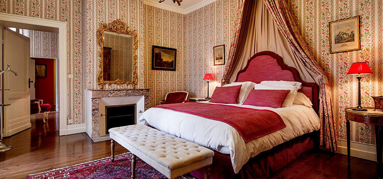 The Promesse suite at Château Fombrague is decorate in florals and shades of Bordeaux