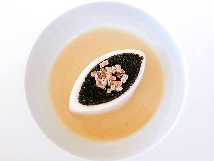 Cauilfower purée is molded into a football shape and topped with a layer of Beluga caviar and some croutons, then vodka sauce is poured in the bowl at Restaurant Lalique at Chateau Lafaurie Peyraguey