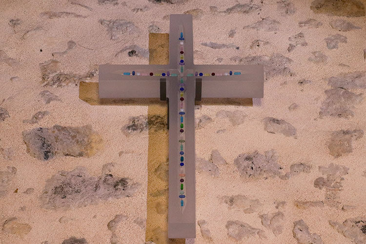 A Lalique cross with multicolored pieces of Lalique crystal in the middle in the chapel at Chateau Lafaurie Peyraguey