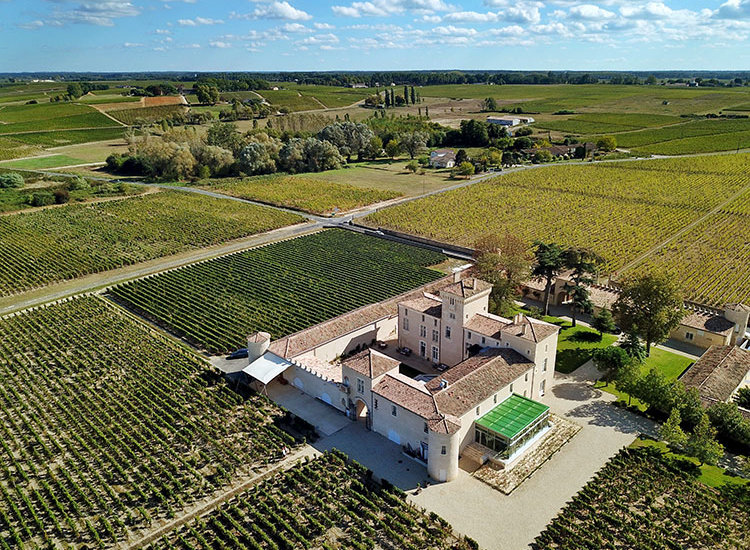 Aerial drone photo of the small castle and surrounding vineyards at Chateau Lafaurie Peyraguey