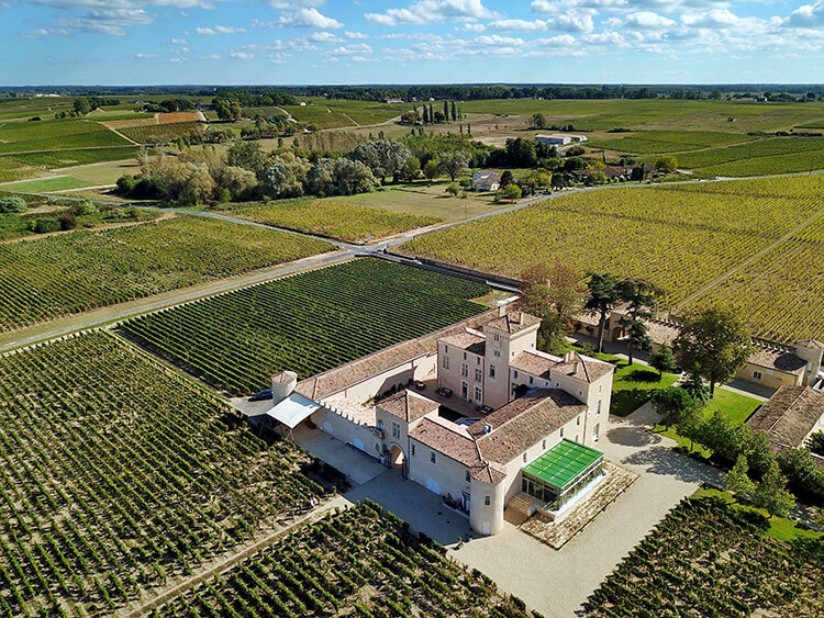 Aerial drone photo of the small castle and surrounding vineyards at Chateau Lafaurie Peyraguey