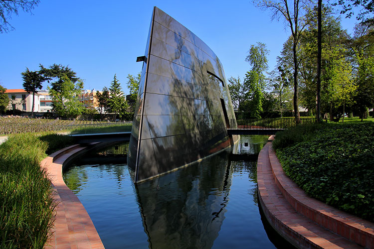 The 21st century winery designed by Philippe Starck looks like an upside down ship suspended in water at Château Les Carmes Haut-Brion