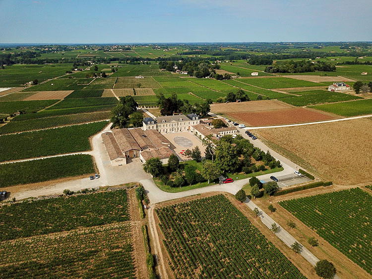 An aerial drone view of Chateau Soutard and the surrounding vines in Saint-Émilion