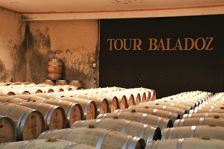French oka barrels fill the barrel room at Château Tour Baladoz