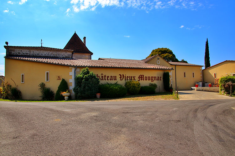 The yellow Chateau Vieux Mougnac with it's dove cote tower