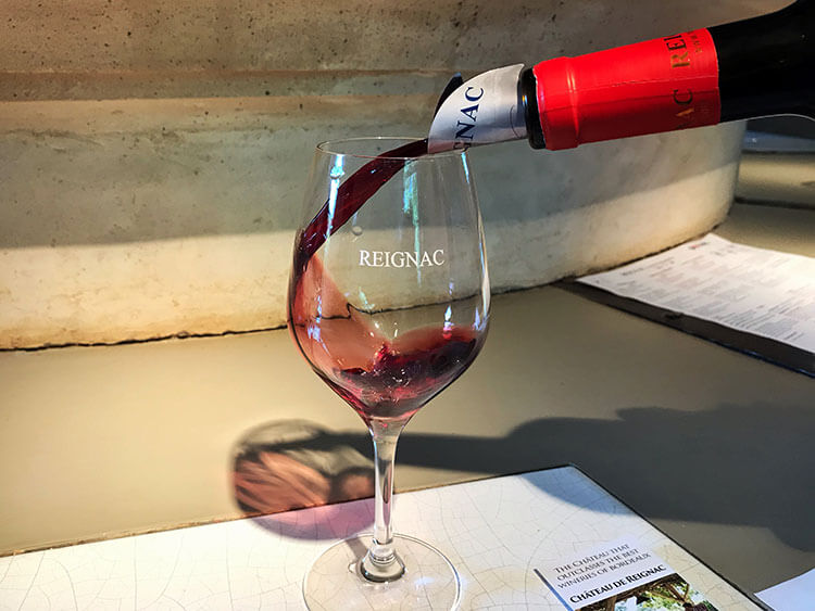 Reignac being poured into a wine glass at Château de Reignac