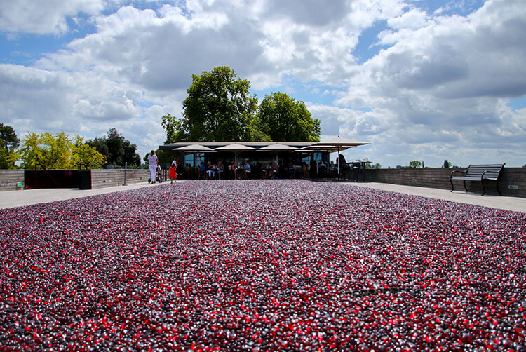 A close up of the red pebbles with the outdoor tables beyond at La Terrasse Rouge