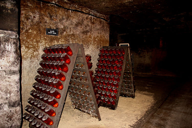 Rosé aging and fermenting in riddling racks in the tunnels of Les Cordeliers