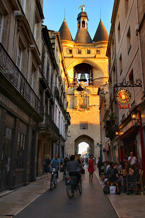 The Grosse Cloche glows golden at sunset at the start of Rue Saint James