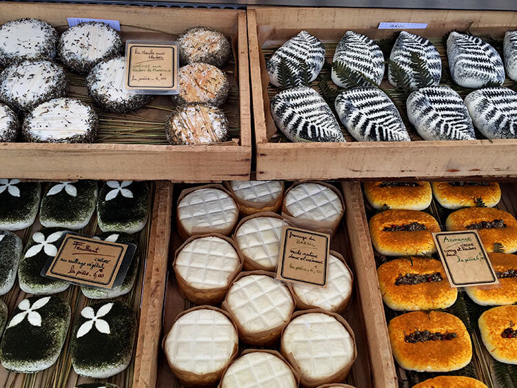 Various kinds of goat cheese with herbs at Marché du Quais