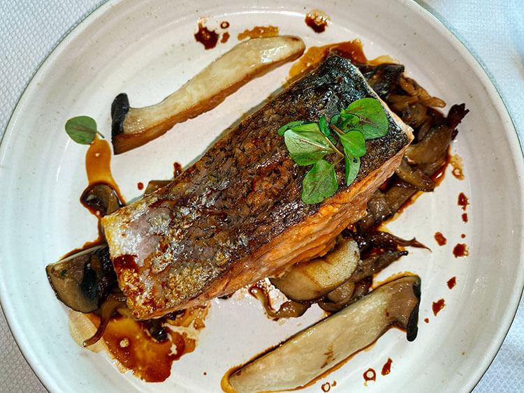 A samon filet on a bed of mushrooms at Château Grand Barrail in Saint-Émilion