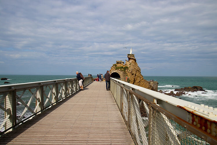 Walking on the metal bridge halfway to the Virgin Rock