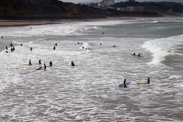 Dozens of surf students in the water at Plage de la Côtes des Basques
