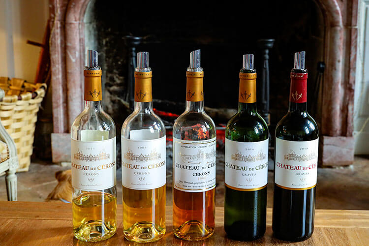 A line up of the 2011, 2008 and 1998 vintages of Château de Cérons, along with bottles of 2016 and 2018 vintages of Château de Cérons Graves