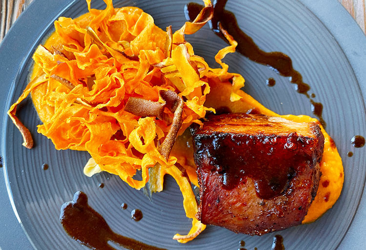 15 hour slow cooked pork belly served with mashed sweet potatoes and sweet potato chips at Atelier de Candale