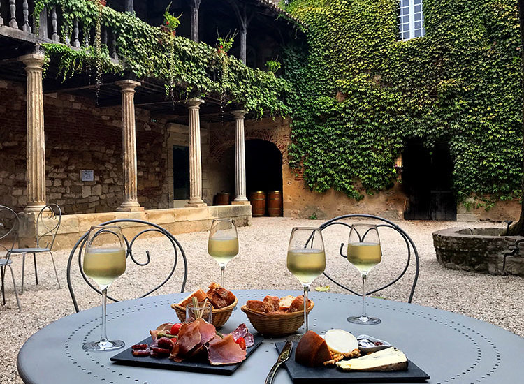 The 17th century Cloître des Récollets with tables for enjoying the wine bar offerings of the Quai Cyrano in Bergerac