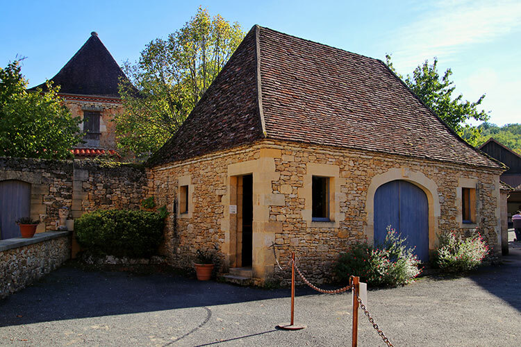 The old farmhouse that houses the mill and press at the Ecomusée de la Noix
