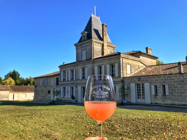 A glass of freshly crushed Merlot grape juice is the color of watermelon juice at Chateau du Tailhas in Pomerol