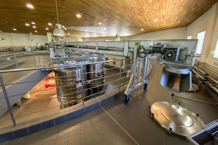 The innovative arm of the gravity fed system in the circular vat room at Château de la Dauphine