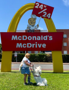 Jennifer and Coco high five in front of the vintage McDonald's Drive sign at the McDonald's V-O in Villenave-d'Ornon