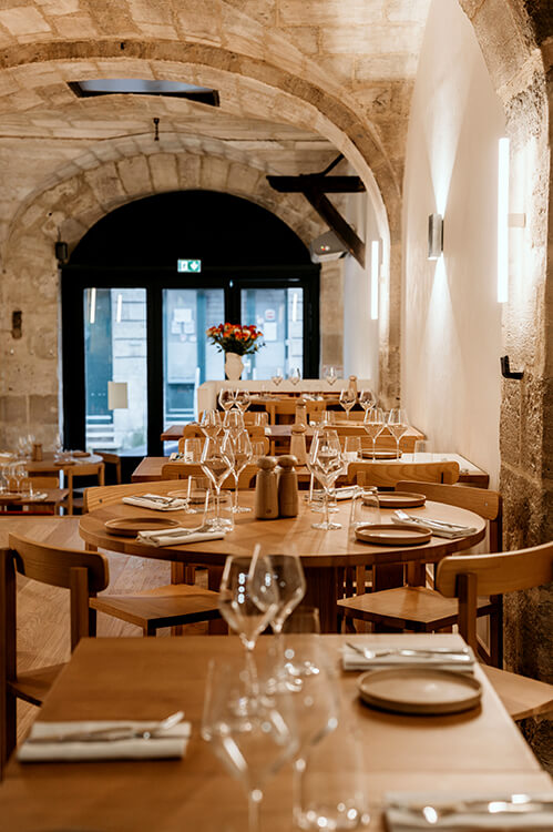 View of the stone walled dining room at OST Restaurant Bordeaux