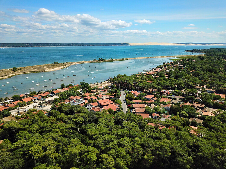 A drone shot of Cap Ferret with beaches and the view of the Dune du Pilat across the Bassin d'Arcachon