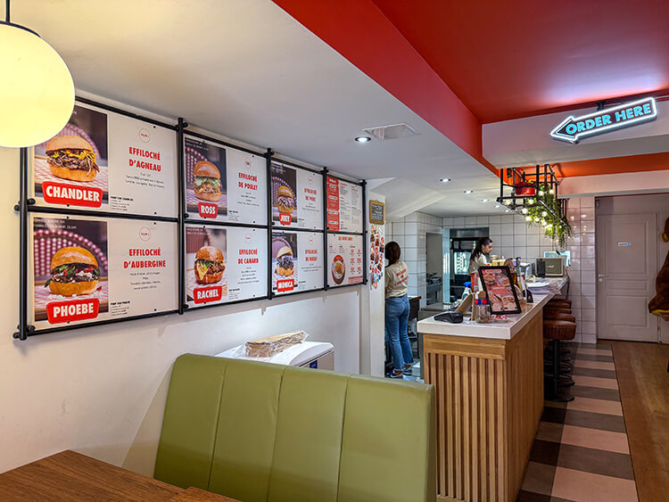 The vintage American diner inspired interior of Bunami with green leather booths 