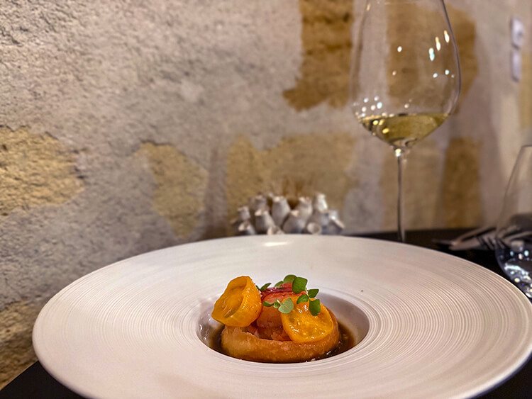 Breton bleu lobster topped with tomatoes in a vanilla and umeboshi sauce at INIMA