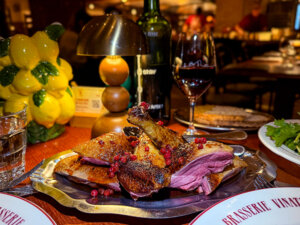 Duck cooked in the wood fireplace and carved into breast and legs at Brasserie Vinatier