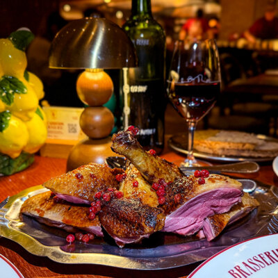 Duck cooked in the wood fireplace and carved into breast and legs at Brasserie Vinatier