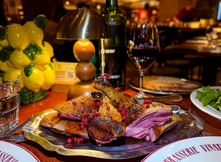 Duck cooked in the wood fireplace and carved into breast and legs at Brasserie Vinatier