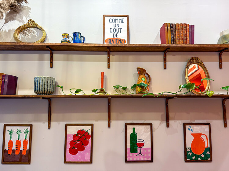 The bookshelves in Filoche with various artworks, books, and ceramics